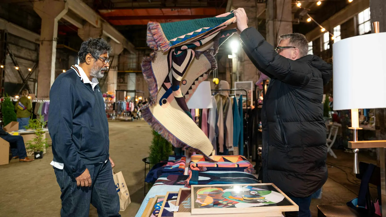 Visitors at a stall at a craft fair