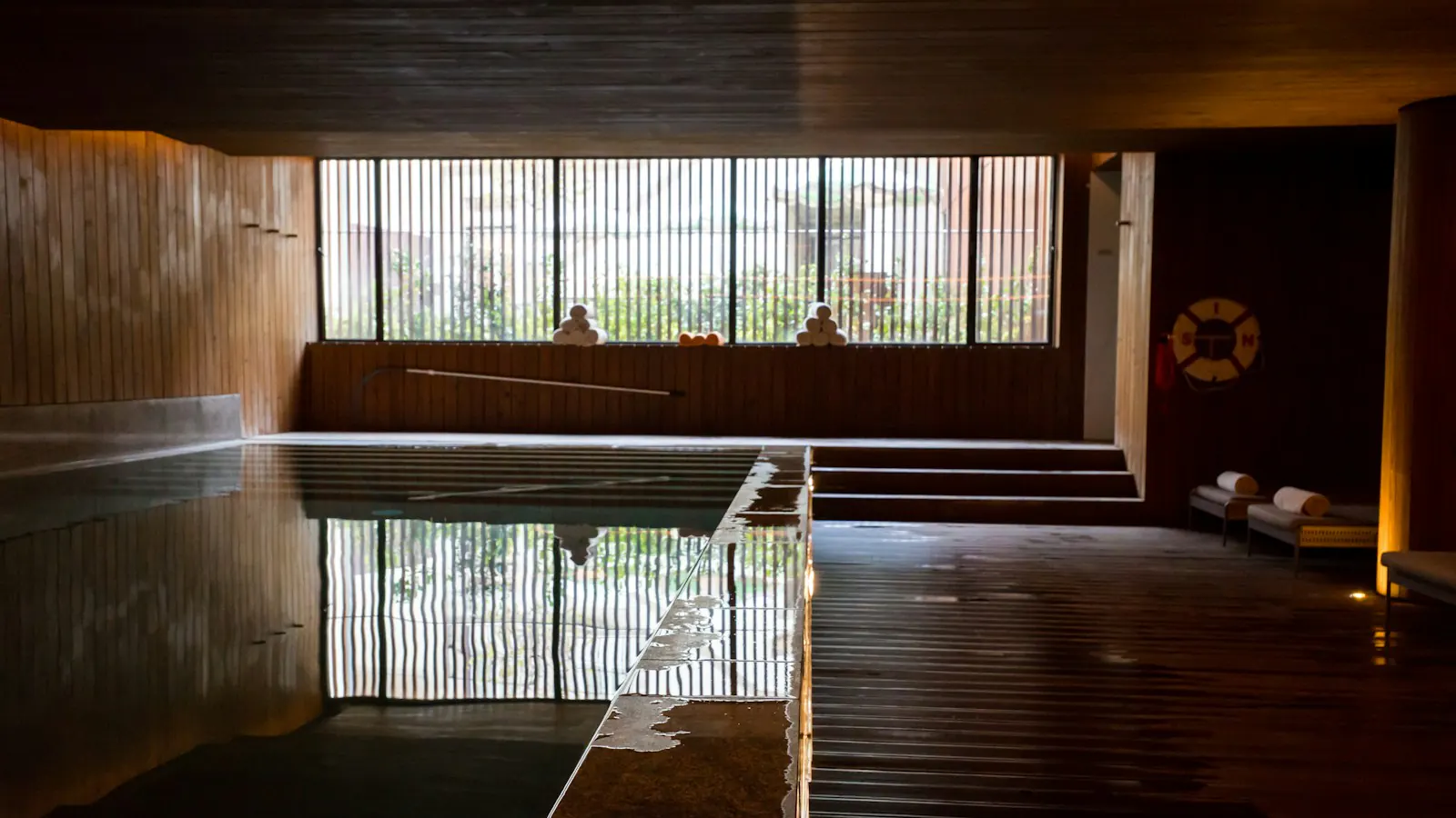 An indoor pool with wooden walls at a spa