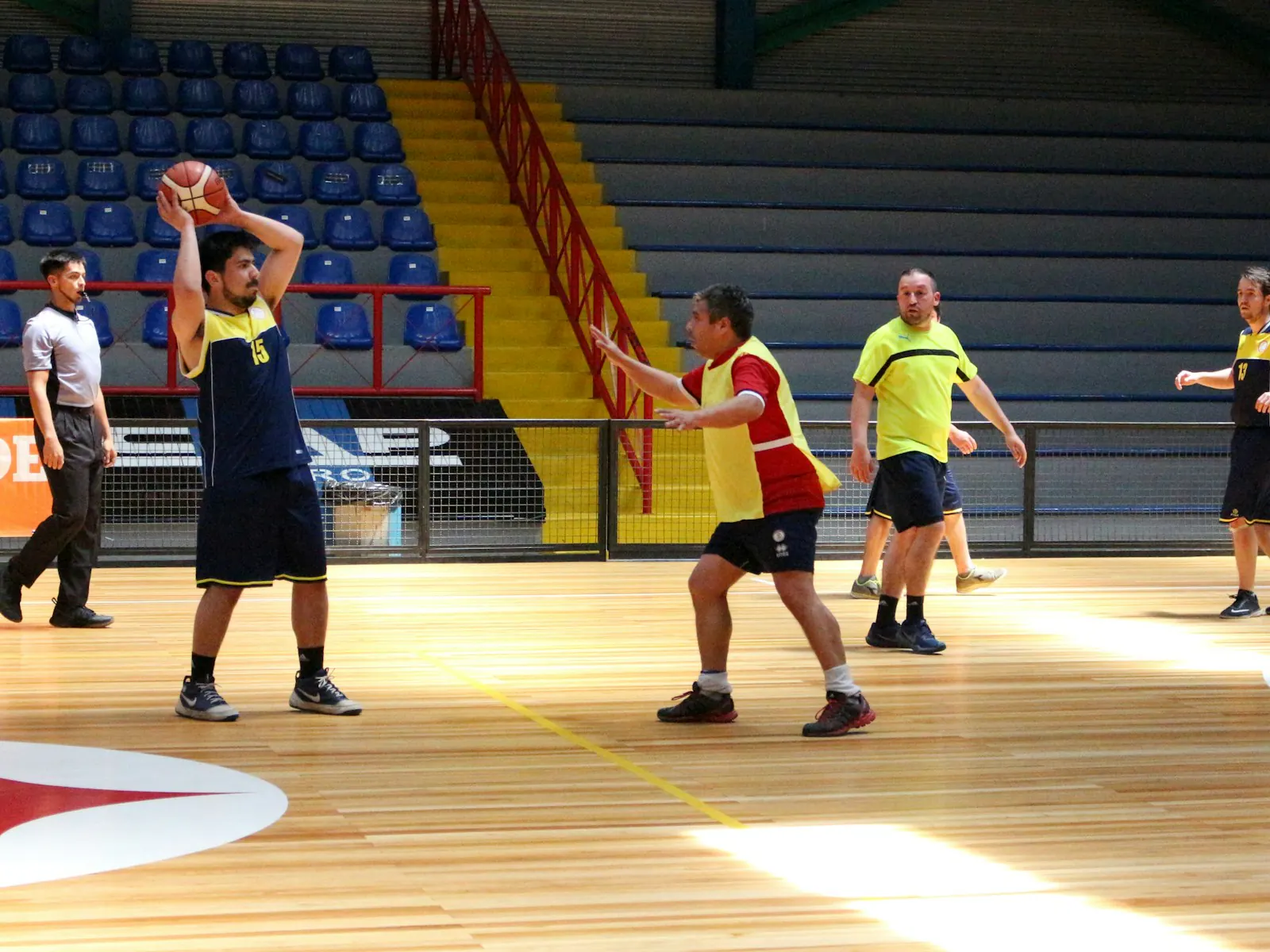 An amateur basketball match in a sports hall